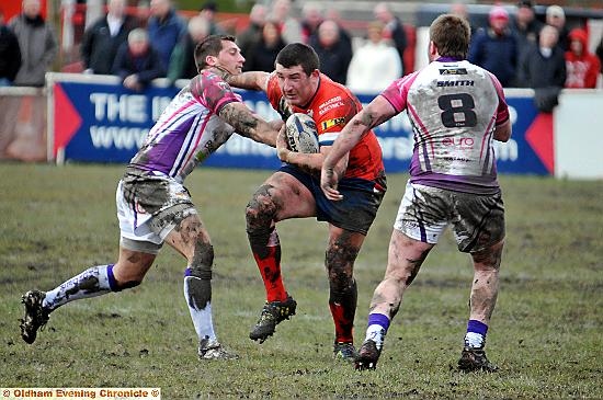 OLDHAM prop Lee Gilchrist powers between two Gateshead Thunder opponents. OLDHAM prop Lee Gilchrist powers between two Gateshead Thunder opponents.