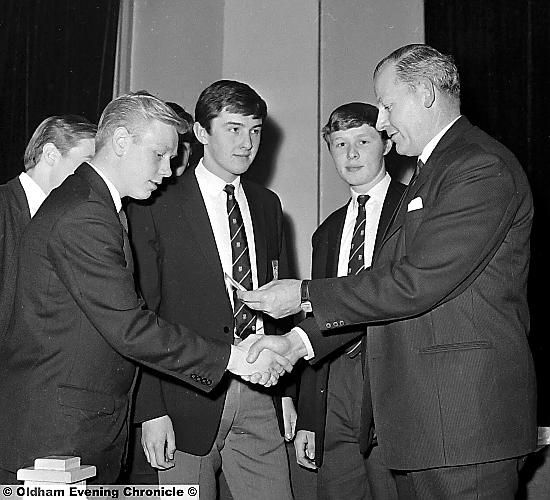 Walter Winterbottom former England soccer manager, presents badges to Oldham Rugby Union Colts from The Festival of Sport. 
