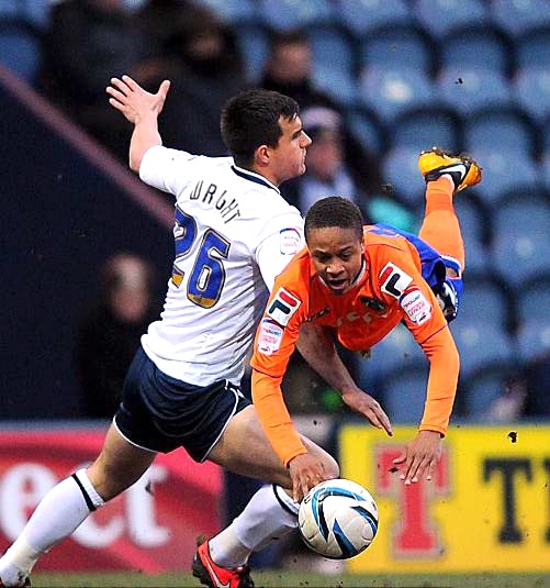 FALLING STAR . . . Athletic’s Bobby Reid is brought down by Bailey Wright. 