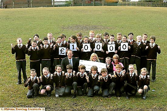 CHARITY boost . . . presenting £10,000 are St Joseph’s Steve Hill (middle row, left), and his Year 6 class, Kate Puc of Francis House (middle) and Shane Keating with teaching assistant Carole Morrison (middle, right) 
