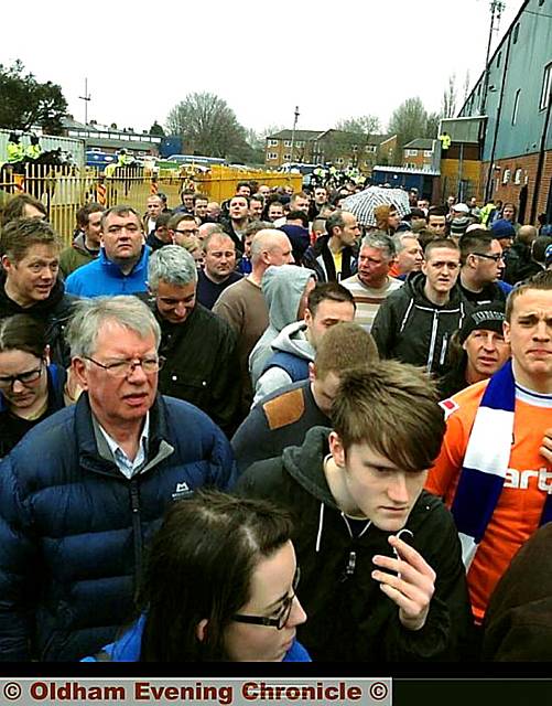 The queue of hopeful spectators locked out of the half-empty ground 
