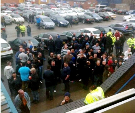 LOCKED OUT fans gather angrily outside the Gigg Lane ground 