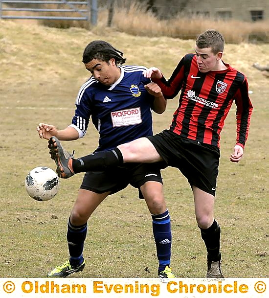 CLOSE QUARTERS . . . Uppermill's Joe Longmoor (right) makes a challenge
CLOSE QUARTERS . . . Uppermill's Joe Longmoor (right) makes a challenge