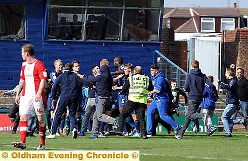 Fans invade the pitch and surround Jean-Yves Mvoto after his winning goal
Fans invade the pitch and surround Jean-Yves Mvoto after his winning goal