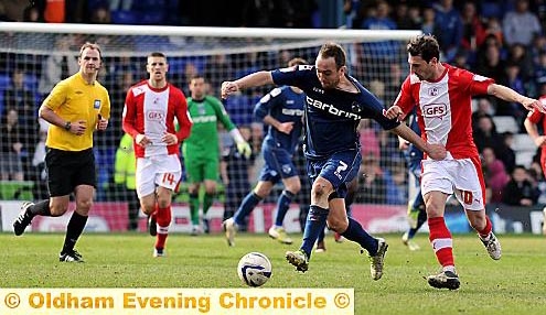 Athletic winger Lee Croft gets a tug on his shirt as he tries to set up an attack. Athletic winger Lee Croft gets a tug on his shirt as he tries to set up an attack.