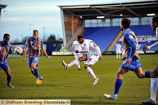ATHLETIC’S Bobby Reid tries to guide his shot through the Shrewsbury defence in last night’s League Once clash. 