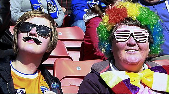 NICE ‘tache! Two Oldham fans bask in the sunshine of a final draw  

