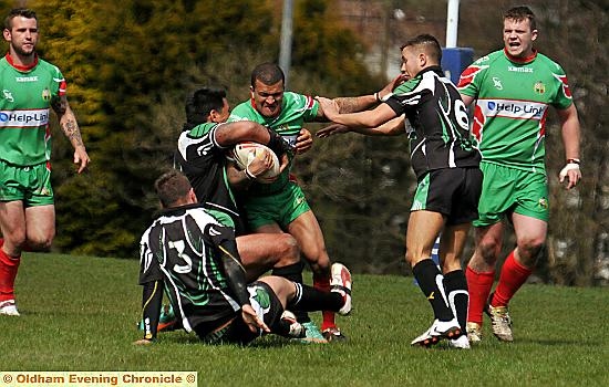 surrounded: Waterhead’s Frazer Coley has nowhere to go as he attempts to burst through the Milford Marlins line. 