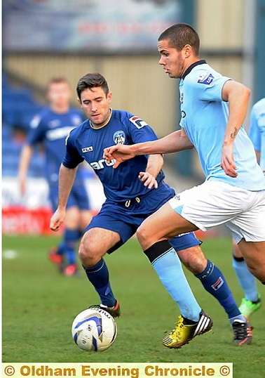 Athletic boss Lee Johnson played for Athletic reserves in their 4-0 Manchester Senior Cup defeat at the hands of Manchester City at Boundary Park. Here he is tracking hat-trick scorer Jack Rodwell. 
