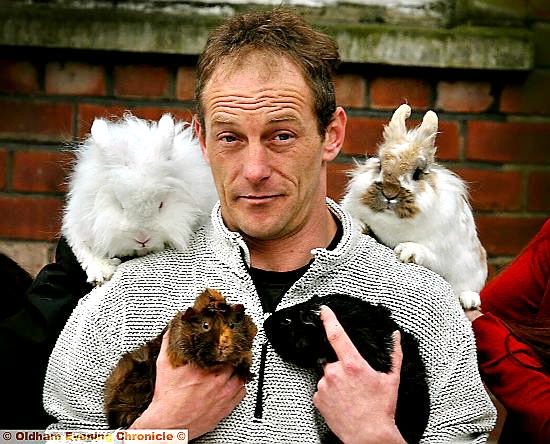 FLUFFY Foursome . . . Mark Hilton with the rescued rabbits and guinea pigs. FLUFFY Foursome . . . Mark Hilton with the rescued rabbits and guinea pigs.