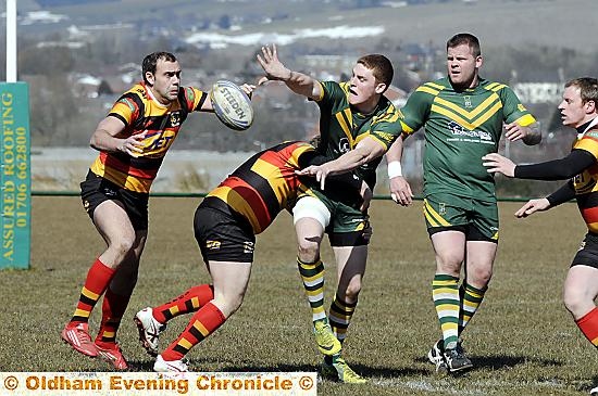 UNDER PRESSURE . . . Saints’ John Deakin offloads as two Shaw Cross tacklers close in. UNDER PRESSURE . . . Saints’ John Deakin offloads as two Shaw Cross tacklers close in.