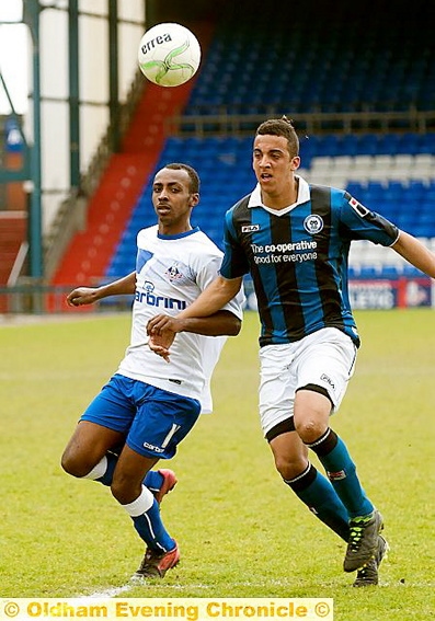 GOING FOR IT: Oldham’s Nathan Eastmond (left) makes a challenge. 