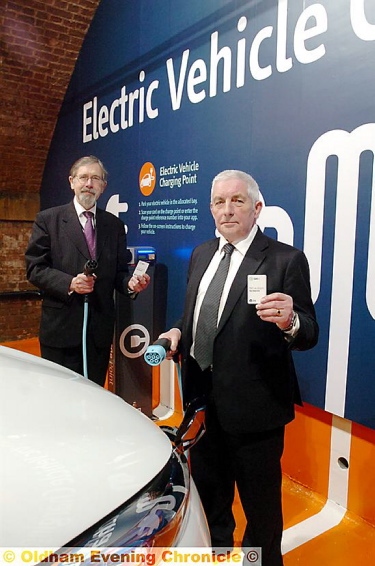PLUG and go: Councillor David Hibbert (right) with chairman of Transport for Greater Manchester Andrew Fender 
