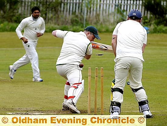 CLEANED UP . . . Glodwick batsman Brad Heap is bowled by Austerlands hero Imran Aslam. CLEANED UP . . . Glodwick batsman Brad Heap is bowled by Austerlands hero Imran Aslam.