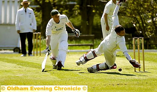 CLOSE SHAVE . . . Shaw batsman Joe Whitehead survives a run out attempt by Heyside ’keeper James Cummins. 
