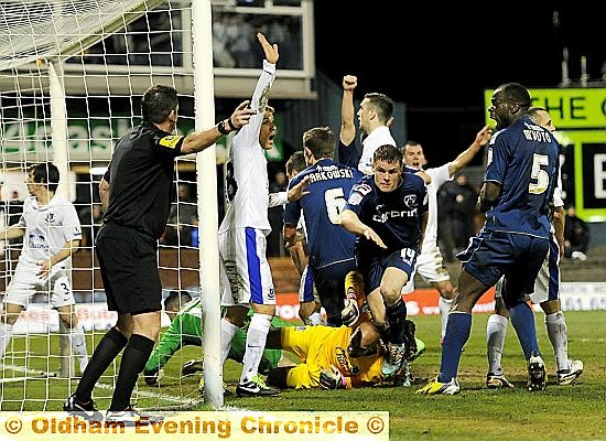 Oldham Athletic's Matt Smith (centre) celebrates scoring his teams second goal of the game during the FA Cup fifth round match at Boundary Park, Oldham. 