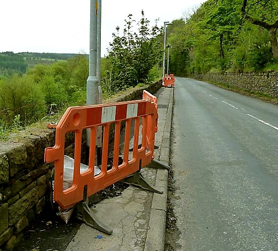 BLOCKED . . . barriers around lamp posts in Sugar Lane, Dobcross force pedestrians into the road 
