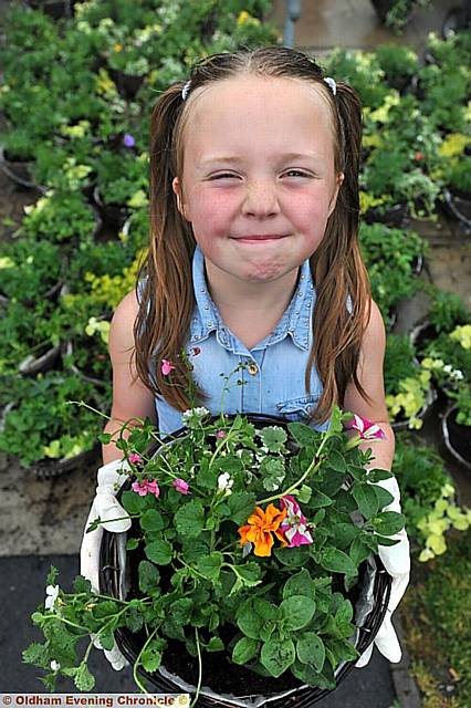 Casey Diveney (7) gets her green fingers dirty for the cause 
