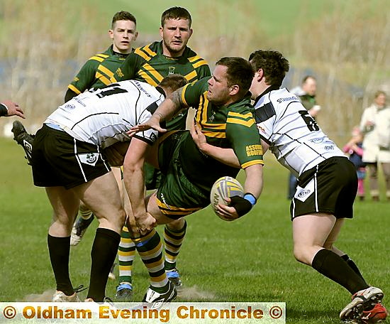 UNDER PRESSURE . . . St Annes’ David Best is tackled by two Stanningley defenders, but still gets his pass away. 