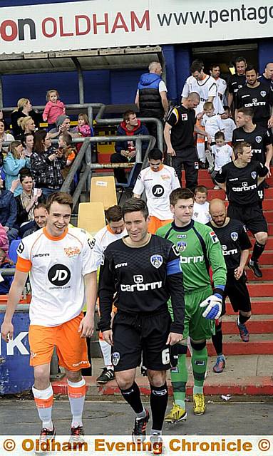 HAT-TRICK hero: Latics boss Lee Johnson (front, right) leads out the Legends. HAT-TRICK hero: Latics boss Lee Johnson (front, right) leads out the Legends.