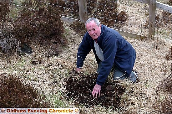 DANGER: concerned Ray Taylor uncovers a mine shaft on Crompton Moor DANGER: concerned Ray Taylor uncovers a mine shaft on Crompton Moor