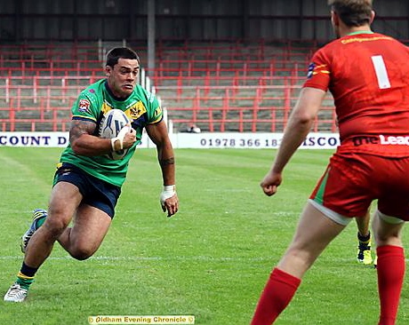 Oldham’s Sam Gee runs hard at the Crusaders defence. 