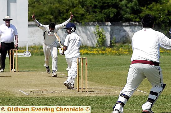 CELEBRATION: Ashton bowling hero Naweed Ghany raises his arms after claiming the wicket of Oldham batsman Hamza Hussain at the Pollards. CELEBRATION: Ashton bowling hero Naweed Ghany raises his arms after claiming the wicket of Oldham batsman Hamza Hussain at the Pollards.