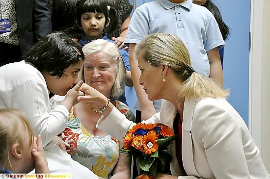 Aalya Idress, a pupil at the special school, gives the Countess a kiss on the hand as a thank-you for her visit 