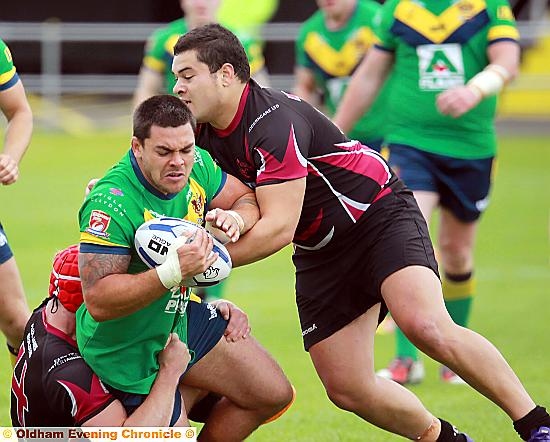 HALTED . . . Oldham's Sam Gee is stopped by the Scorpions defence. 