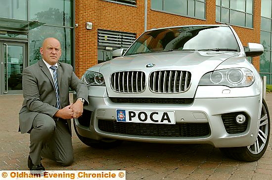 DCI Rick Jackson with a BMW X5 seized by police DCI Rick Jackson with a BMW X5 seized by police