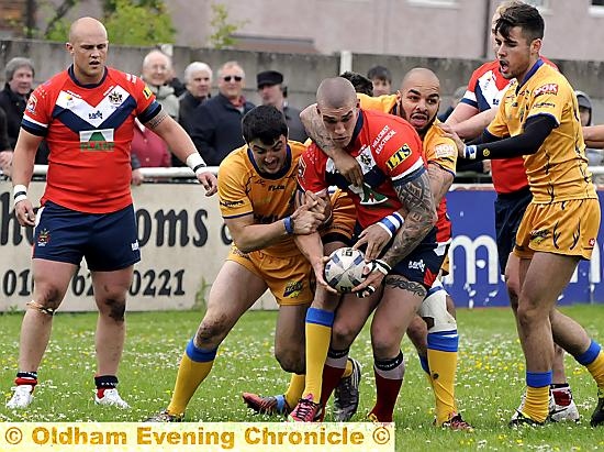 UNDER PRESSURE: Oldham’s David Cookson holds possession. 