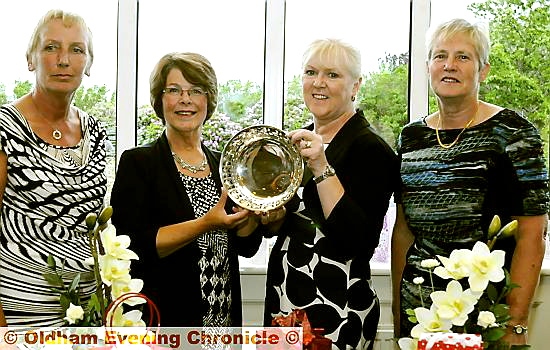 ALL YOURS: Audrey Whittaker (second left) receives the Crompton and Royton Lady Captain’s Day trophy from lady captain Lynn Truelove. They are flanked by Brenda Keaney (left, first-day prize) and Jennifer Kenworthy (second-day prize). ALL YOURS: Audrey Whittaker (second left) receives the Crompton and Royton Lady Captain’s Day trophy from lady captain Lynn Truelove. They are flanked by Brenda Keaney (left, first-day prize) and Jennifer Kenworthy (second-day prize).
