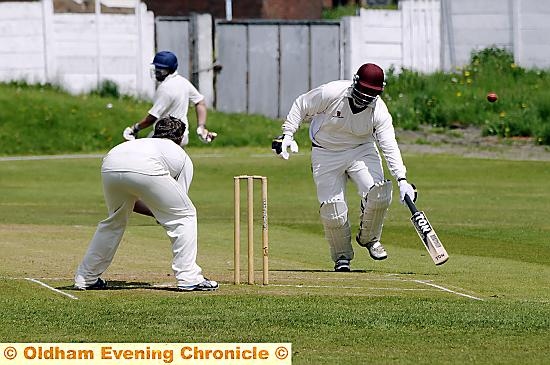 Ashton batsman Janak Patel beats the ball as Royton bowler Chris Hutchinson looks on. Ashton batsman Janak Patel beats the ball as Royton bowler Chris Hutchinson looks on.