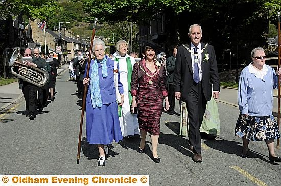 LEADING the way: Saddleworth Parish Council chairman Councillor Graham Sheldon and his wife and consort, Diane, at the head of the procession in Chew Valley Road
LEADING the way: Saddleworth Parish Council chairman Councillor Graham Sheldon and his wife and consort, Diane, at the head of the procession in Chew Valley Road