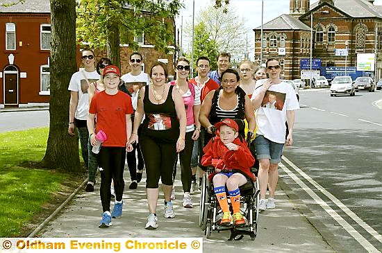 BLISTERS won’t beat us . . . Emily Hester, Anita Claxton, Jenna Goddard and Adam McQuillan lead the walk from Manchester Children’s Hospital to Uppermill 
