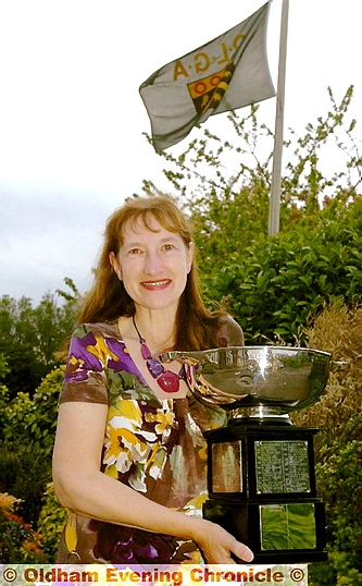GLYNIS Jones shows off the Chronicle Cup as the flies at half mast behind her. GLYNIS Jones shows off the Chronicle Cup as the flies at half mast behind her.