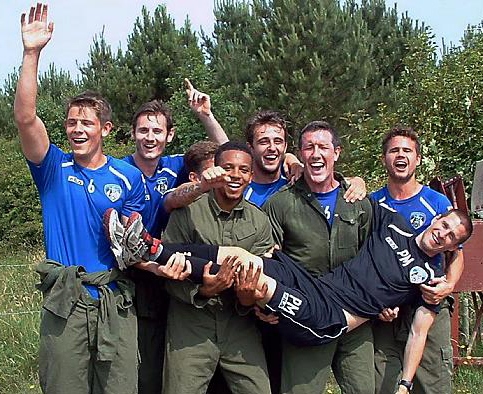 WE’RE STILL STANDING: team members with coach Paul Murray 
