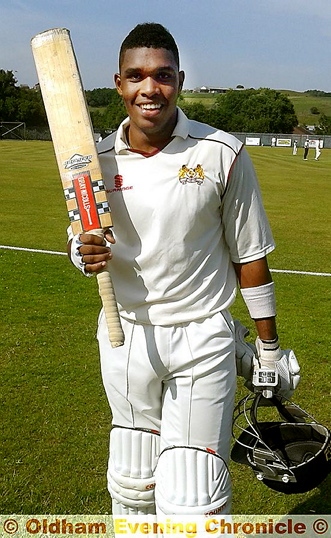 SUPER SHOW . . . Denis Louis takes the plaudits after his record-breaking knock against brave Oldham. 