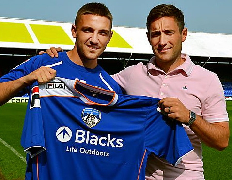 NEW KID ON THE BLOCK: Anton Rodgers gets a warm welcome from Athletic manager Lee Johnson. 