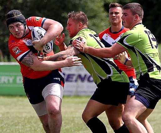 TWO AGAINST ONE . . . Oldham’s Michael Ward attempts to brush aside his South Wales Scorpions opponents. 