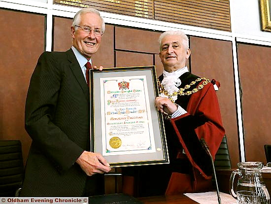 HONOUR: Oldham Mayor Councillor John Hudson presents Mr Meacher with a framed scroll. Picture: Anthony Miller 
