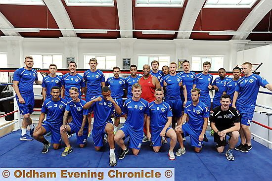 RARING TO GO . . . Eric Noi poses with the Athletic players before the tough work-out. 

