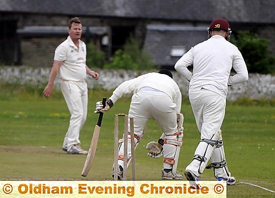 Friarmere batsman Atif Khan is bowled by Saddleworth bowler Peter Skuse. 