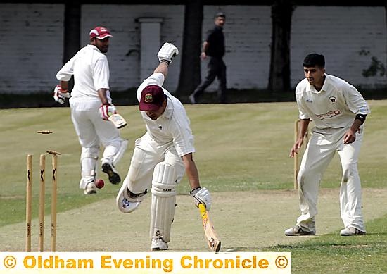 FULL STRETCH . . . Royton batsman Ali Muzaffer, who made an unbeaten 77, survives a run-out scare. 