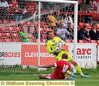 THAT’S MINE . . . Athletic goalkeeper Mark Oxley grabs the ball close to his chest to deny Accrington’s Danny Webber. 
