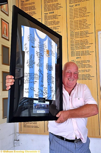 RETIRING . . . Neil Wheelton with his signed shirt 
