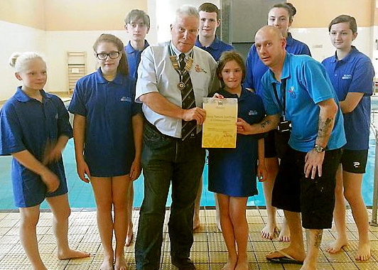 LIFEsaver . . . Caoimhe Preshur (centre) receives her Certificate of Commendation for her brave actions from RLSS UK Manchester and district branch chairman Mike Wardle alongside Rookie Lifeguard instructor Warren Andrews and fellow Rookies 
