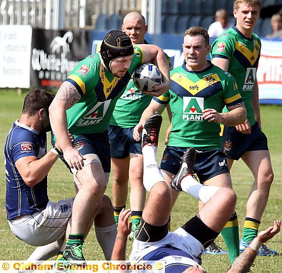 coming through . . . Michael Ward, of Oldham, leaves a trail of Oxford bodies in his wake as he attempts to make ground. 