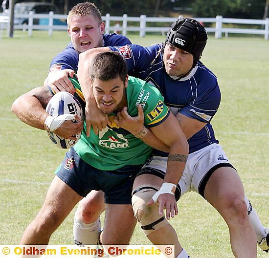 HOLD ON TIGHT . . . Oldham’s Sam Gee has two Oxford players for company. 