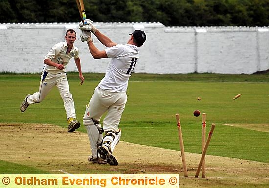 SWING AND A MISS: Heyside batsman Nick Campbell sees his stumps smashed by Greenfield bowler James Ashton. SWING AND A MISS: Heyside batsman Nick Campbell sees his stumps smashed by Greenfield bowler James Ashton.